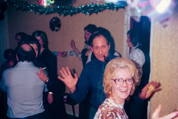 An old photo of a holiday party showing people from the 60's looking festive.